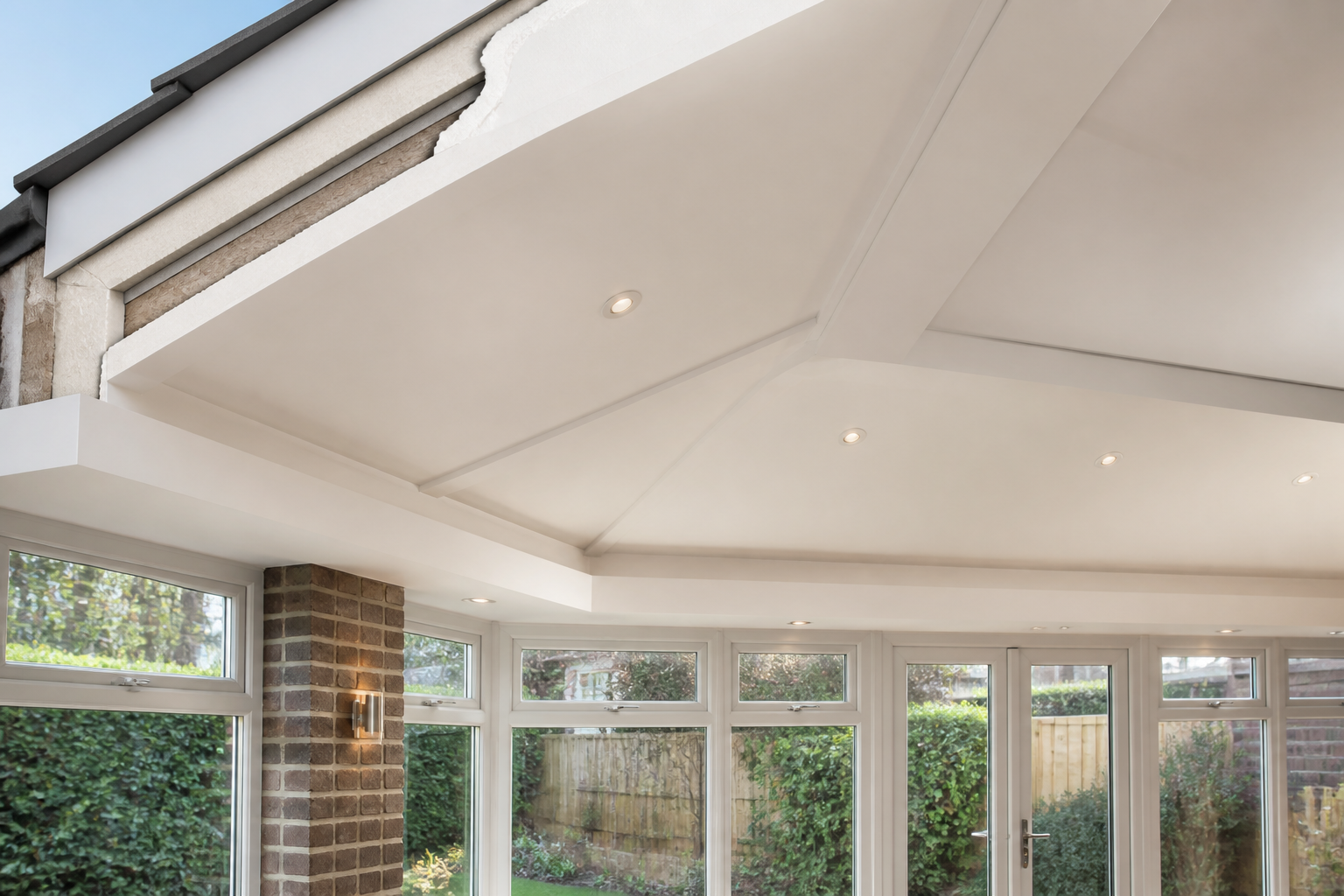 Close-up detail of a high-quality SupaLite insulated warm-roof system on a conservatory, showing the internal finish…